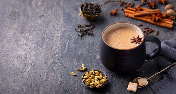 istock Indian masala tea with milk and spices in mug. Grey background. Close up. Copy space. 1276754318