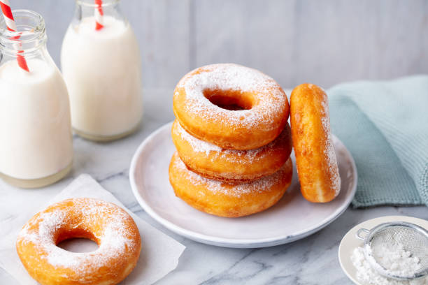 istock Donuts with bottle of milk on marble table. Grey background. Close up. 1276755264