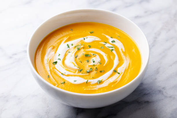 istock Pumpkin soup with cream. Marble background. Close up. 1276756954