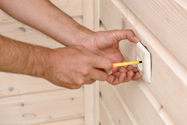 istock Hands of an electrician installing a socket, cutting out a closeup.. 1276757494