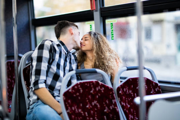 istock Couple kissing on front bus seats 1276760307