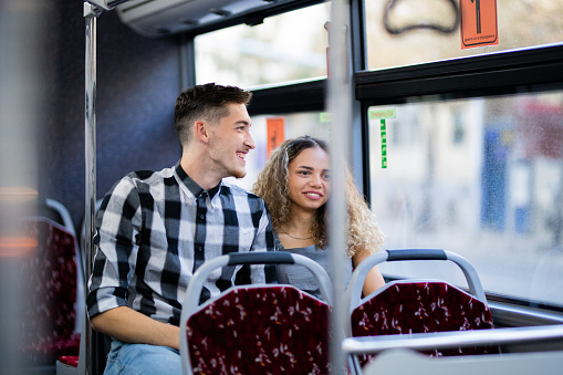 Couple is traveling with public transportation bus.