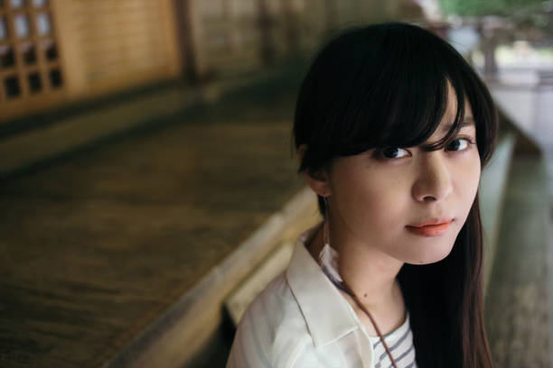a woman with long hair looking at the camera