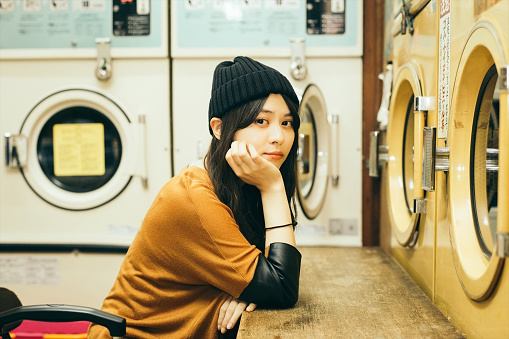 a woman with long hair at the coin laundry