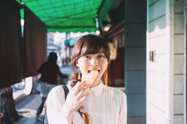istock a woman holding a ice cream 1276761309