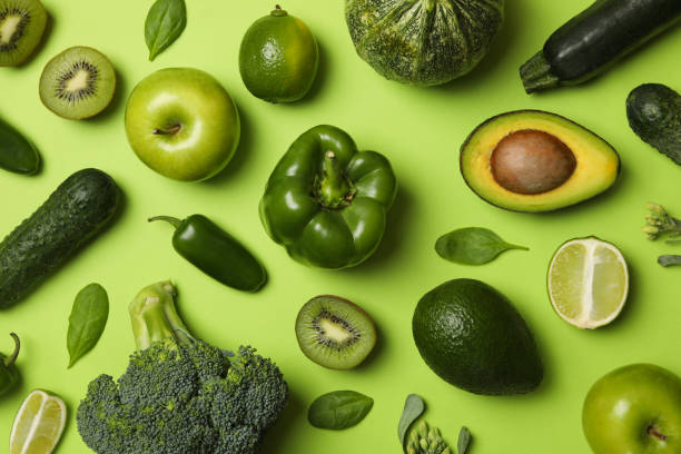 istock Vegetables and fruits on green background, top view 1276762935