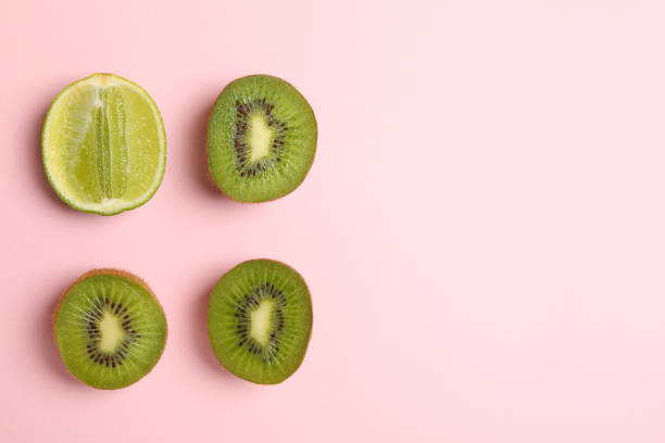 istock Lime and avocado on pink background, space for text 1276763553