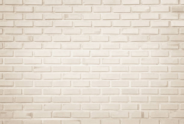 istock Empty Background of wide cream brick wall texture. Old brown brick wall concrete or stone pattern nature, wallpaper limestone abstract floor/Grid uneven interior rock. Home & office design backdrop. 1276763932
