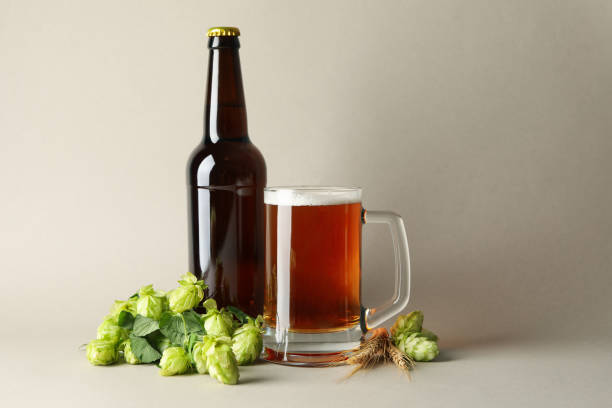 istock Beer and green hop on gray background 1276764827