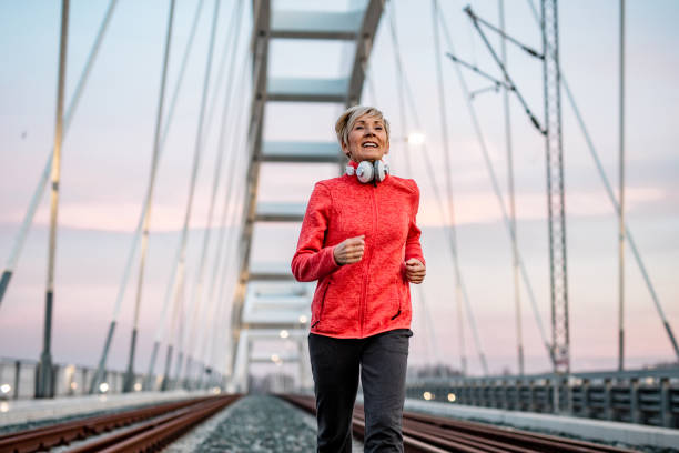istock Senior woman jogging at night 1276766133