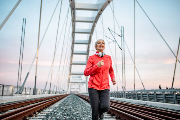 istock Senior woman jogging at night 1276766190