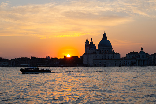 View from the island of San Giorgio of the Venice lagoon, in the background a taxi boat and the basilica of Santa Maria della Salute