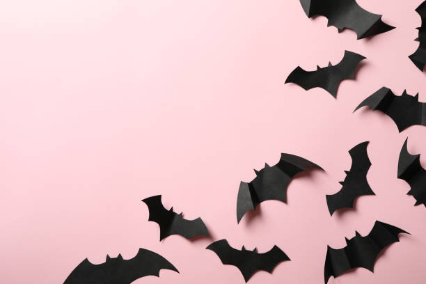 istock Paper bats on pink background, space for text 1276767173
