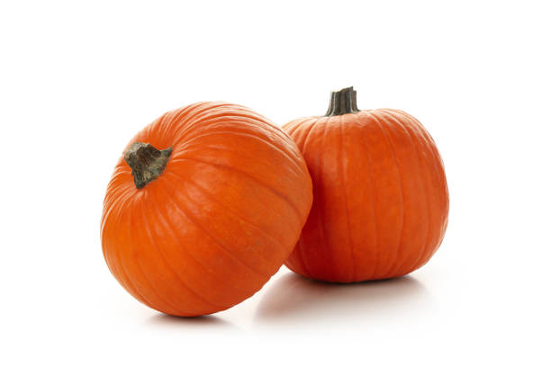 istock Two fresh pumpkins isolated on white background 1276768386