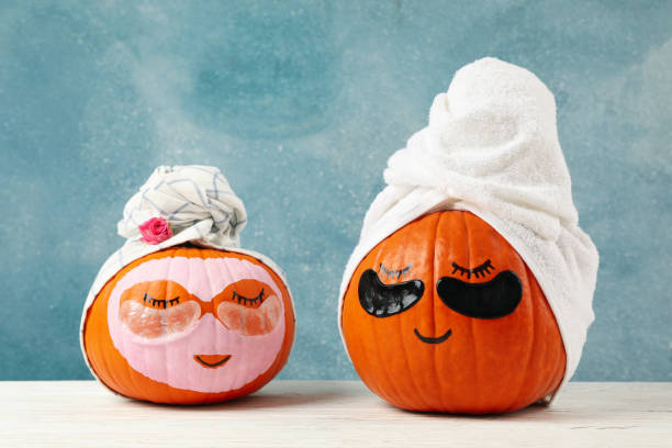 istock Pumpkins with eye patches and towels on blue background 1276768446