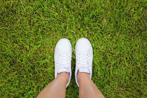 istock Young woman standing in grass 1276769023