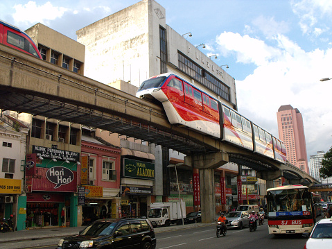 Kuala Lumpur, Malaysia, February 1, 2016: Monorail passing over traffic on a Kuala Lumpur street