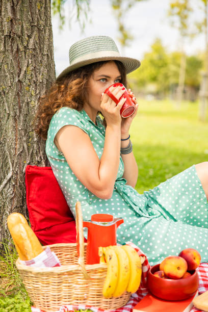 istock Beautiful young woman having picnic 1276772068