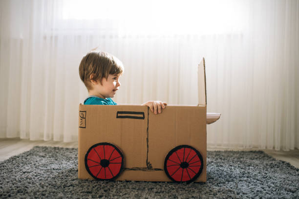 istock Little boy play in the cardboard car 1276772174