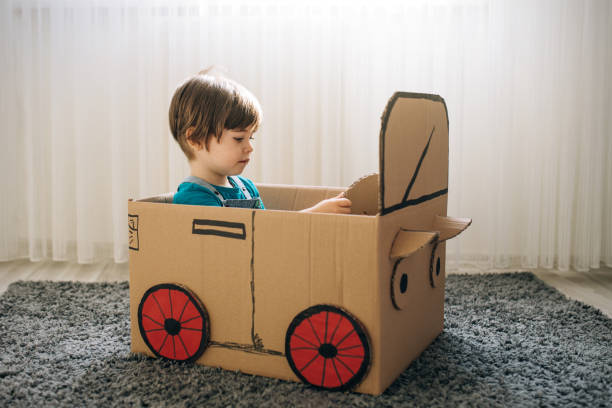 istock Little boy play in the cardboard car 1276772266