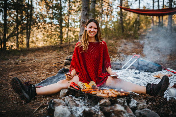 The girl enjoys next to the campfire