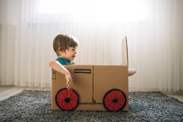 istock Little boy play in the cardboard car 1276773110