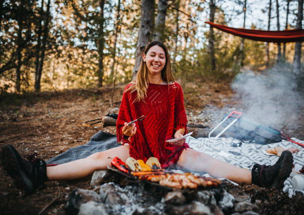 istock The girl enjoys next to the campfire 1276773316