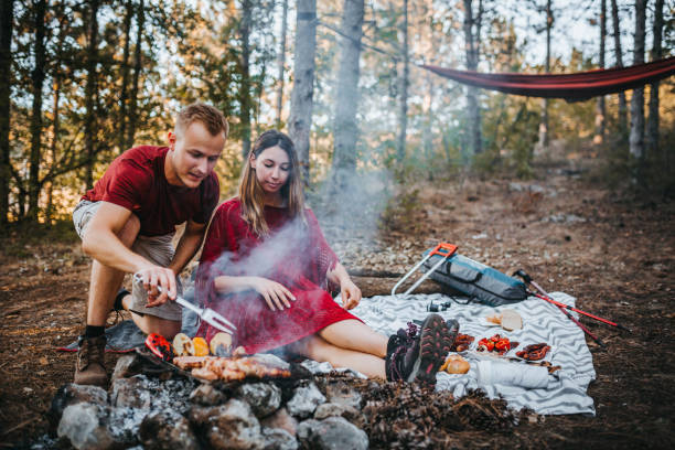 istock Young camping couple cooking meal 1276773344