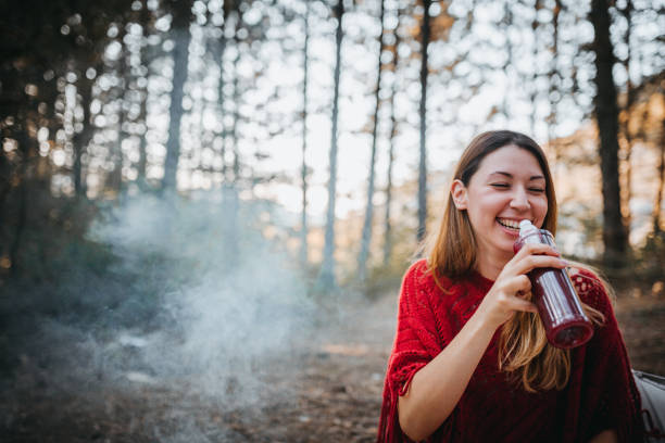 istock The girl enjoys next to the campfire 1276773538