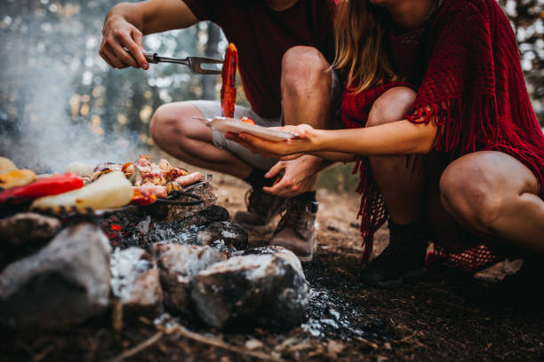 istock Couple cooking food outside 1276774108