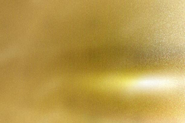 istock Light shining down on gold foil metal plate with copy space, abstract texture background 1276779738
