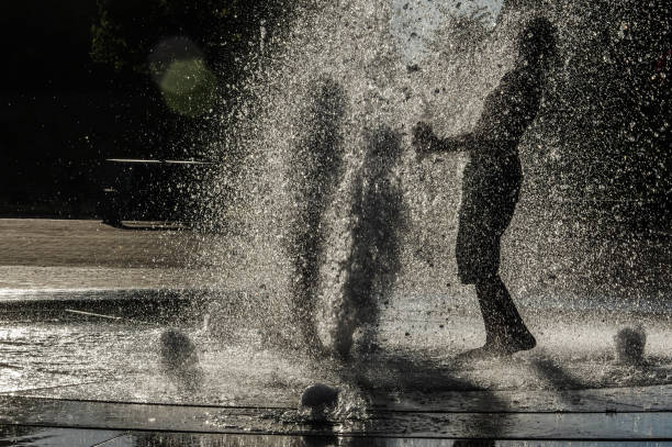 istock Playing in the city fountain 1276780321
