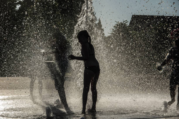 istock Teens Playing in the city fountain 1276780322