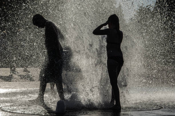 istock Teens Playing in the city fountain 1276780346