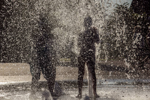 istock Teens Playing in the city fountain 1276780379