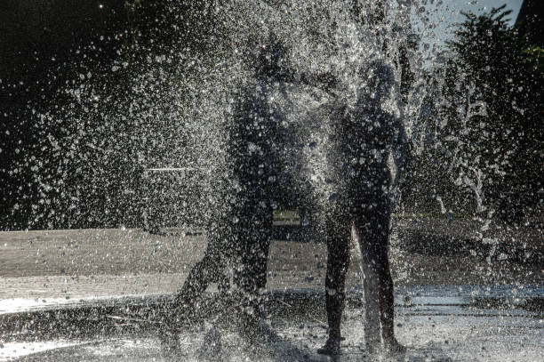 istock Playing in the city fountain 1276780403