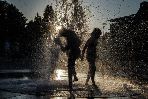 istock Playing in the city fountain 1276780523