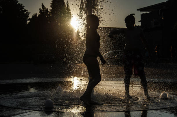istock Playing in the city fountain 1276780609