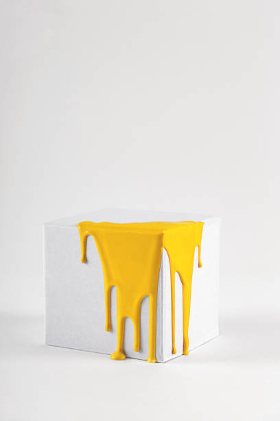 istock White cube with smudges of bright yellow paint 1276782695