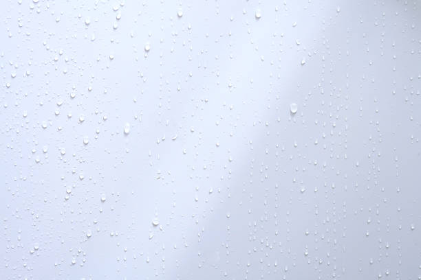 istock Water droplets on the blue wall 1276783977