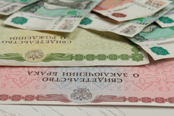 istock birth certificate and paper money lie on a white table 1276787365