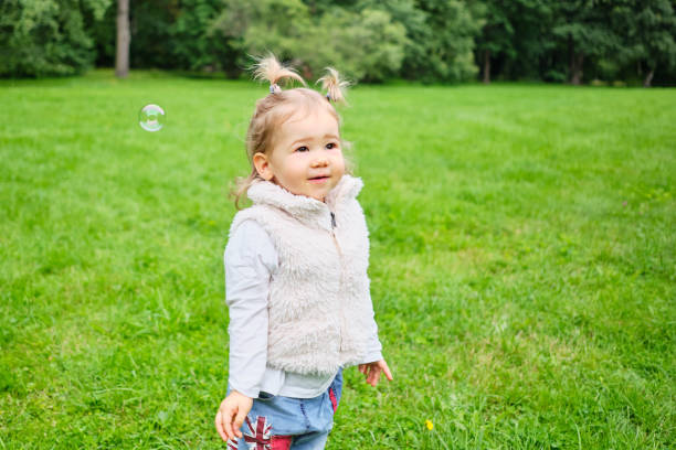 istock Caucasian kid walking in a summer park 1276789699