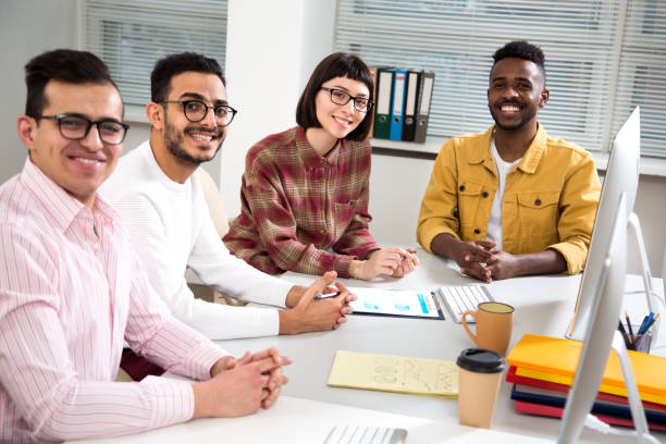 istock Multy-ethnic group of creative business people working with computer at office 1276789989