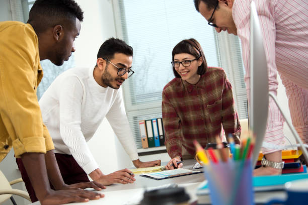 istock Multy-ethnic group of young business people working with computer at office 1276790120