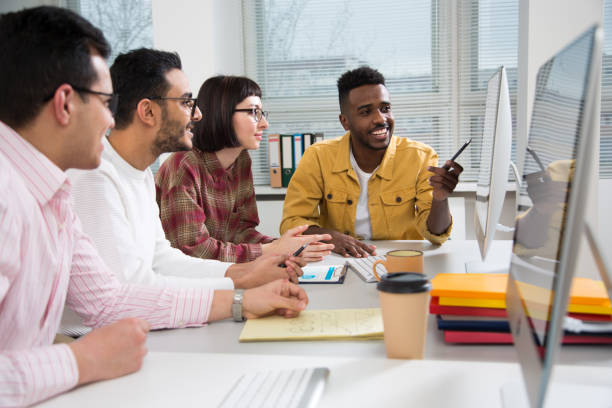 istock Multy-ethnic group of young business people working with computer at office 1276790139