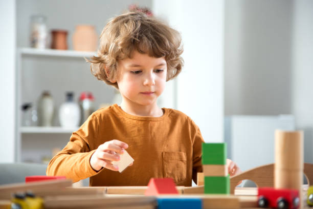 istock Little boy sits at a table and plays with the constructor 1276790194