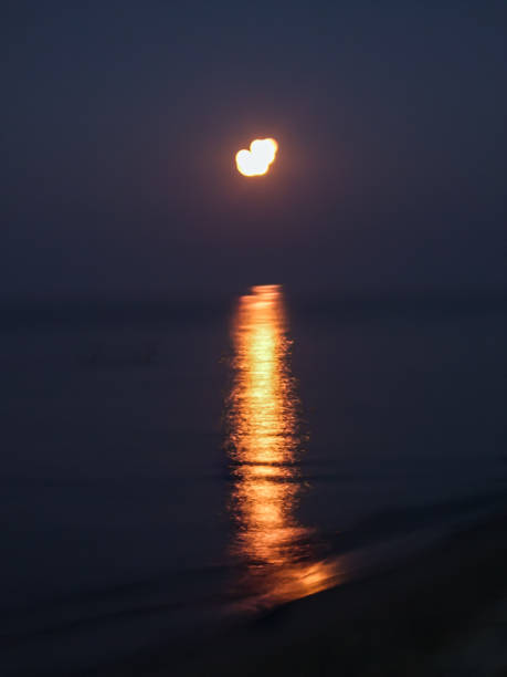 istock Dusk on the Sea Beach with Beautiful Moon Reflection. 1276794618