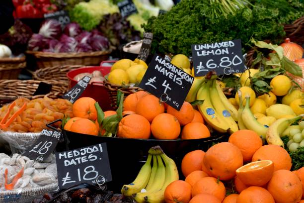 Oranges, bananas, lemons and many other fresh fruits on a market stand