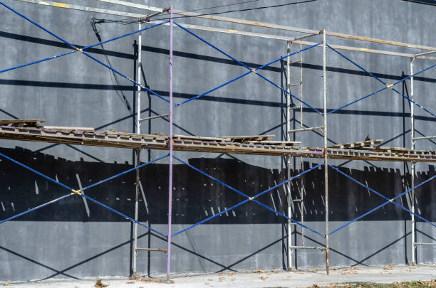 istock Scaffolding near a gray one-story building. 1276802420