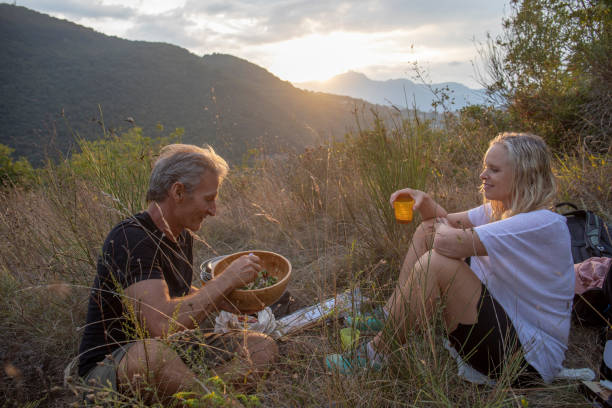 istock Mature couple have bbq dinner on hillside 1276803734